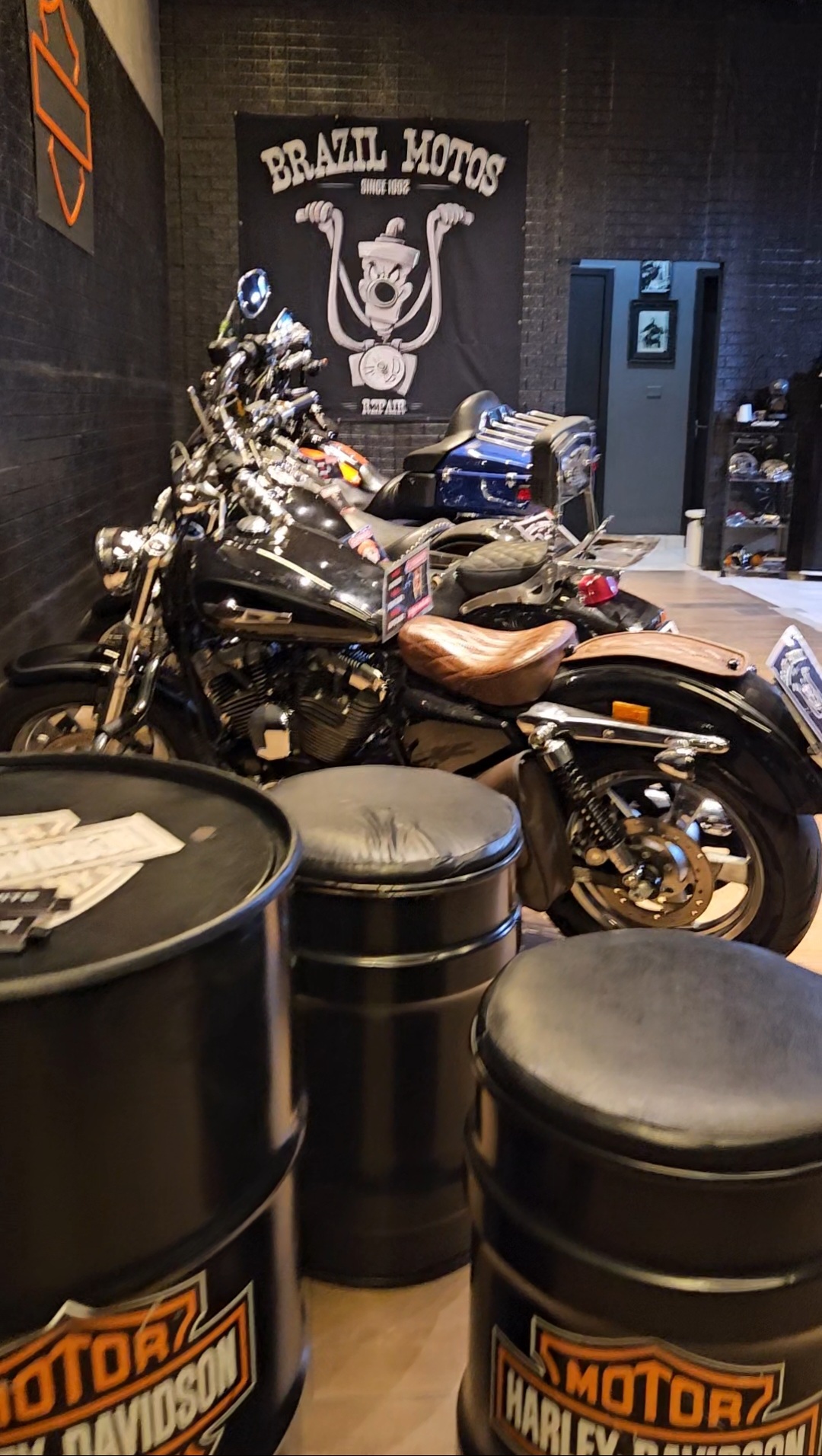 Motocicleta custom exposta na Brazil Motos, com o emblema da marca ao fundo